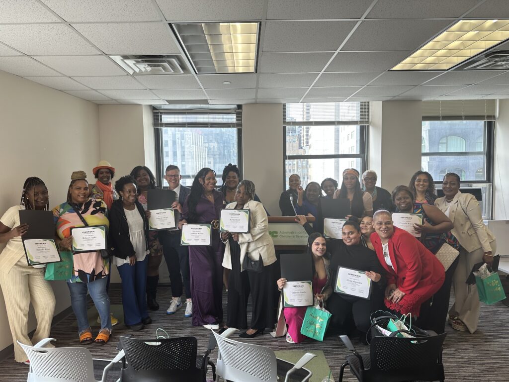 group photo of 2023 graduates holding up their graduation certificates